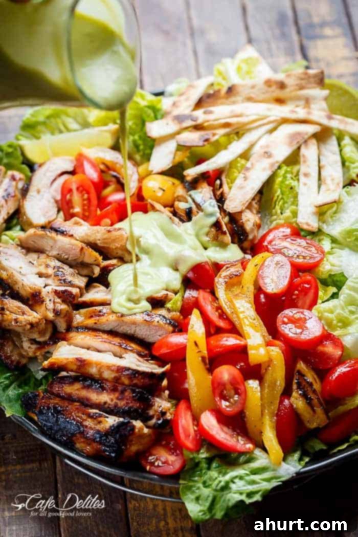 Tequila Lime Grilled Chicken Taco Bowl 6 A dressing dripping over Tequila Lime Chicken Taco Salad