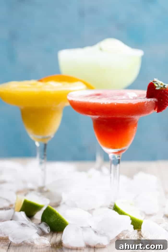 Tropical Strawberry Mango Margaritas 2 Two glasses of refreshing Frozen Strawberry and Mango Margaritas, garnished and ready for a festive celebration. These fruity slushies are even better than the original margarita recipe!