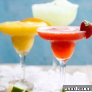 Tropical Strawberry Mango Margaritas 5 Close-up of a Frozen Strawberry and Mango Margarita cocktail in a glass, ready to be enjoyed.
