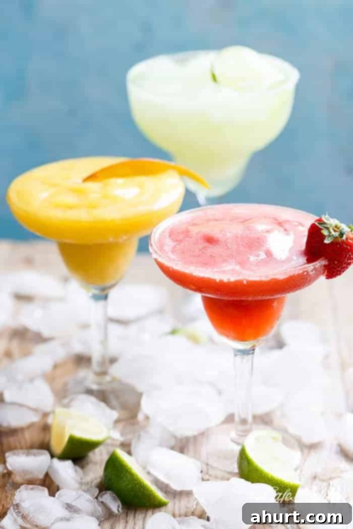 Tropical Strawberry Mango Margaritas 6 A refreshing frozen cocktail in a margarita glass, featuring vibrant colors of strawberry and mango, perfect for a summer day or festive celebration.