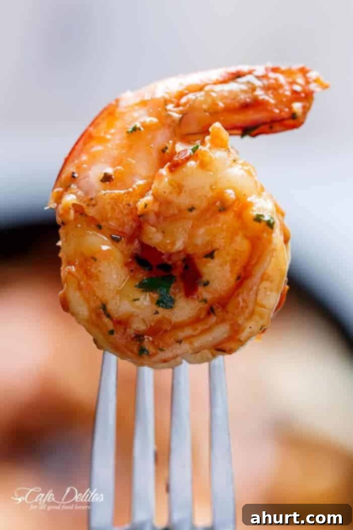 Zesty Sun-Dried Tomato Garlic Shrimp 3 Close-up on a single succulent shrimp piece from the Spicy Garlic Sun Dried Tomato Shrimp dish, showing its beautiful color and seasoning.