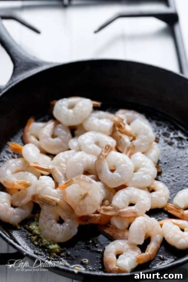 Zesty Sun-Dried Tomato Garlic Shrimp 5 Frying image of Spicy Garlic Sun Dried Tomato Shrimp sizzling in a non-stick pan, showing the cooking process.