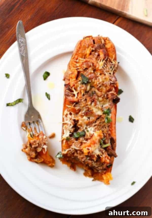 Sweet Potato Boats with Cheesy Bacon Bolognese 8 Top view image of Bacon Bolognese Stuffed Sweet Potatoes on a plate
