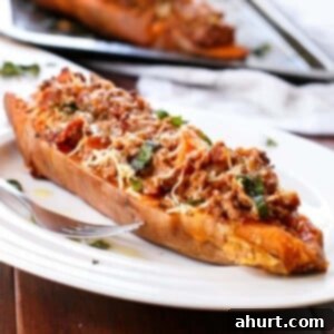 Sweet Potato Boats with Cheesy Bacon Bolognese 9 Cheesy Bacon Bolognese Stuffed Sweet Potatoes on a plate