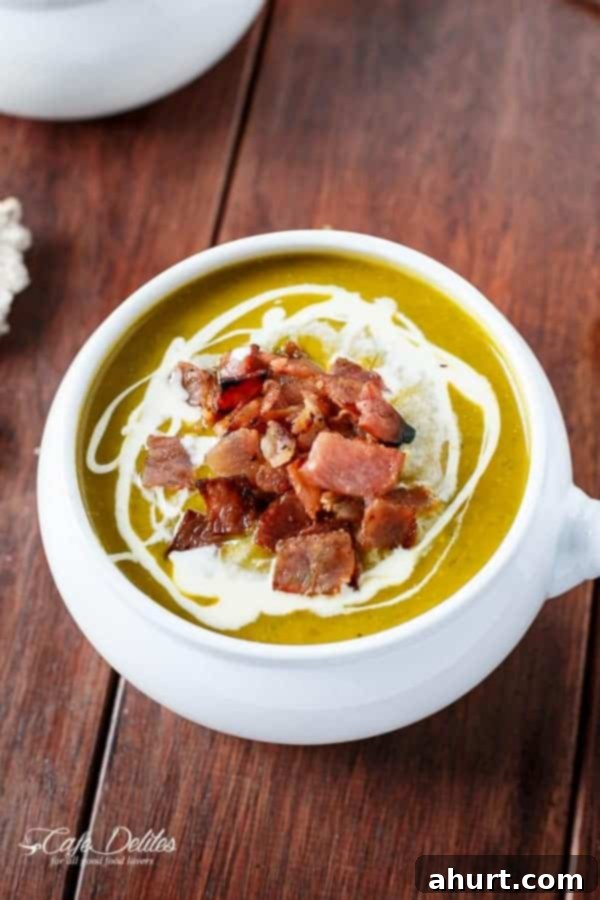 Golden Pumpkin Velouté with Spinach Ribbons and Crispy Bacon Crumble 2 Top view image of Creamy Pumpkin and Spinach Soup with Crispy Bacon in a bowl