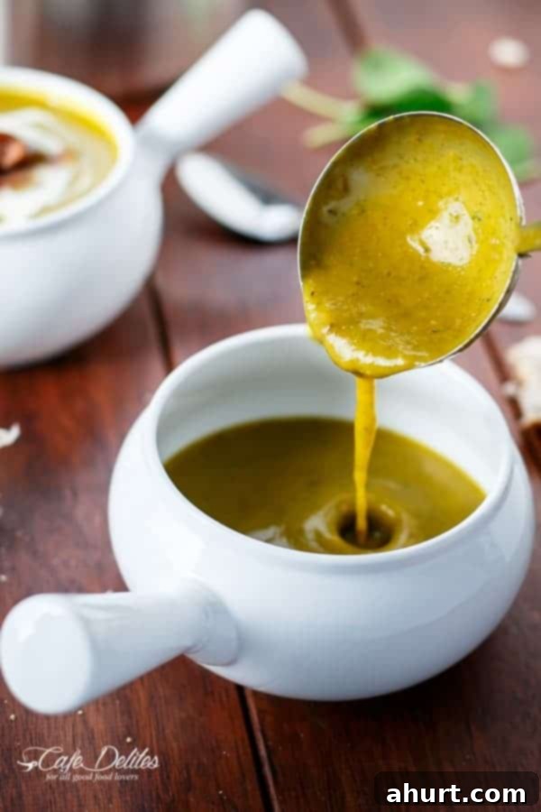 Golden Pumpkin Velouté with Spinach Ribbons and Crispy Bacon Crumble 3 Creamy Pumpkin and Spinach Soup being poured with a huge spoon into the bowl