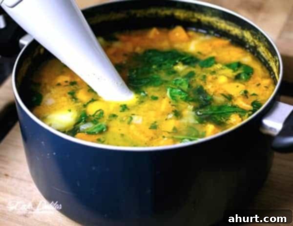 Golden Pumpkin Velouté with Spinach Ribbons and Crispy Bacon Crumble 6 Stirring of Creamy Pumpkin and Spinach Soup in a pot