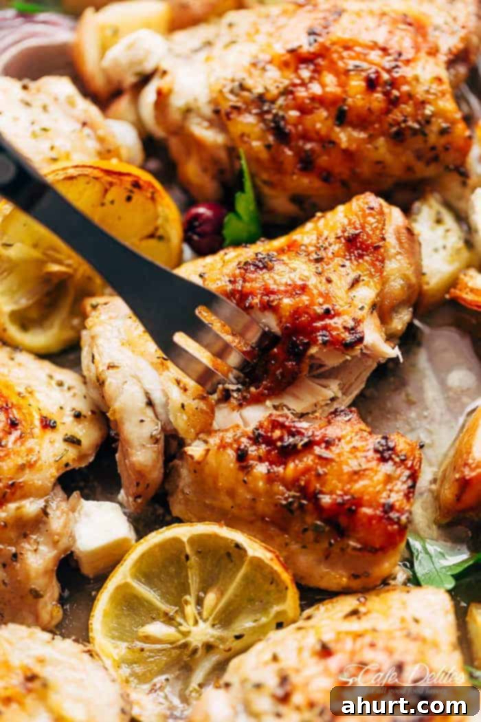 Hellenic Citrus Herb Chicken 4 A fork pierced in a perfectly cooked chicken piece, ready to be enjoyed