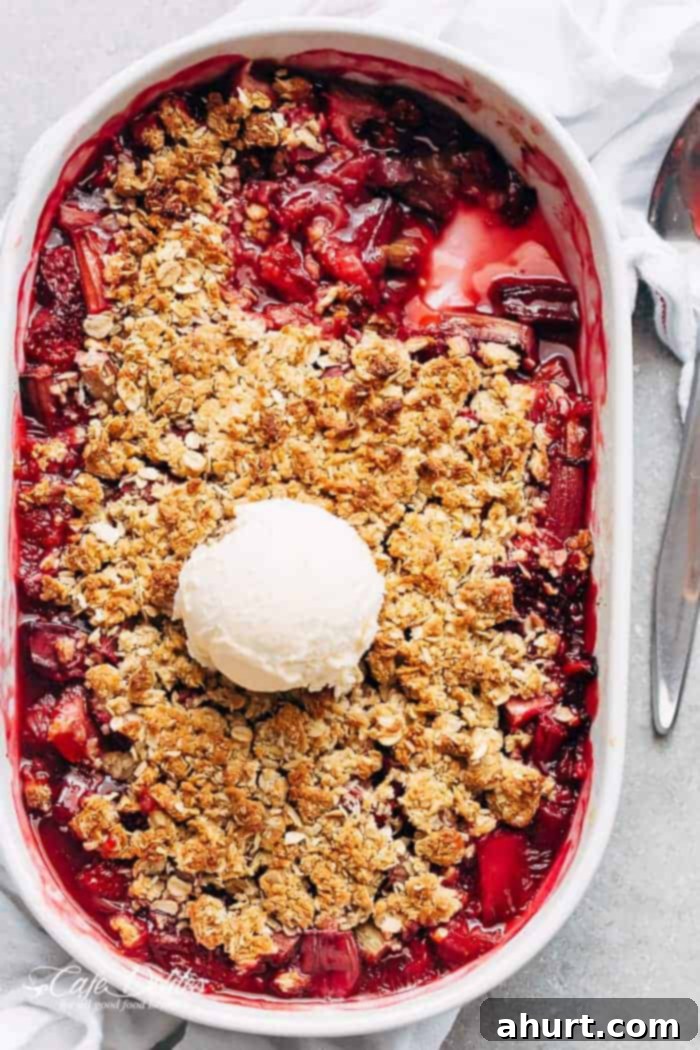Comforting Strawberry Rhubarb Crisp 2 Strawberry Rhubarb Crisp with ice cream scoop, a classic summer dessert