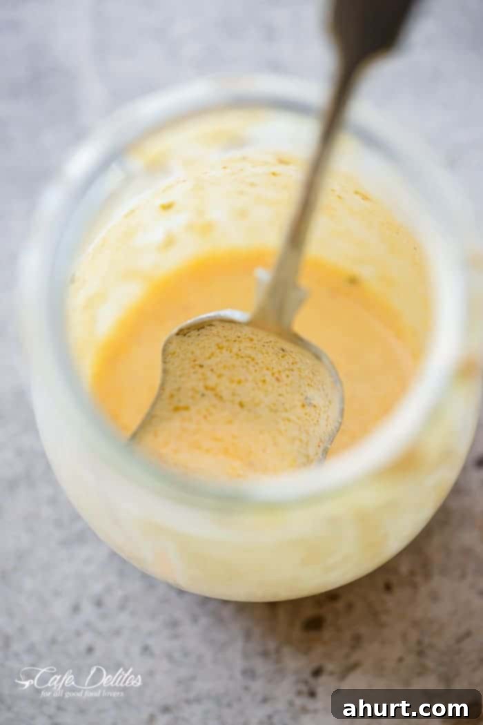 Homemade Cajun spice seasoning blend in a wooden bowl with measuring spoons