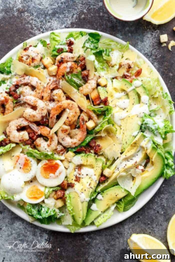 Grilled Lemon Garlic Shrimp Caesar Salad on a platter with creamy dressing and parmesan