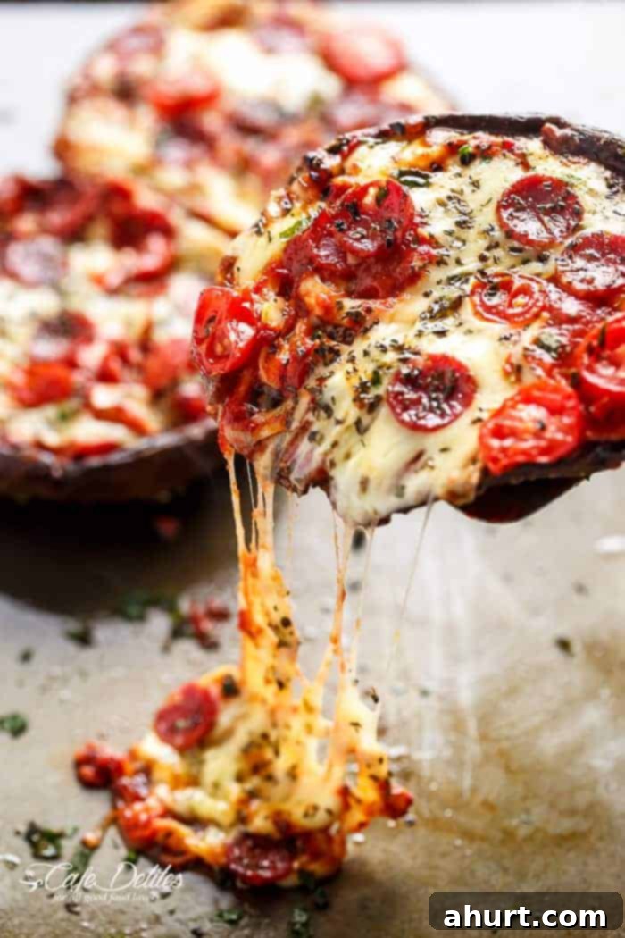 Speedy Portobello Pizza Caps 10 A slice of healthy Portobello Pizza being pulled from the main mushroom cap with a spatula, showcasing the perfectly melted cheese and savory toppings