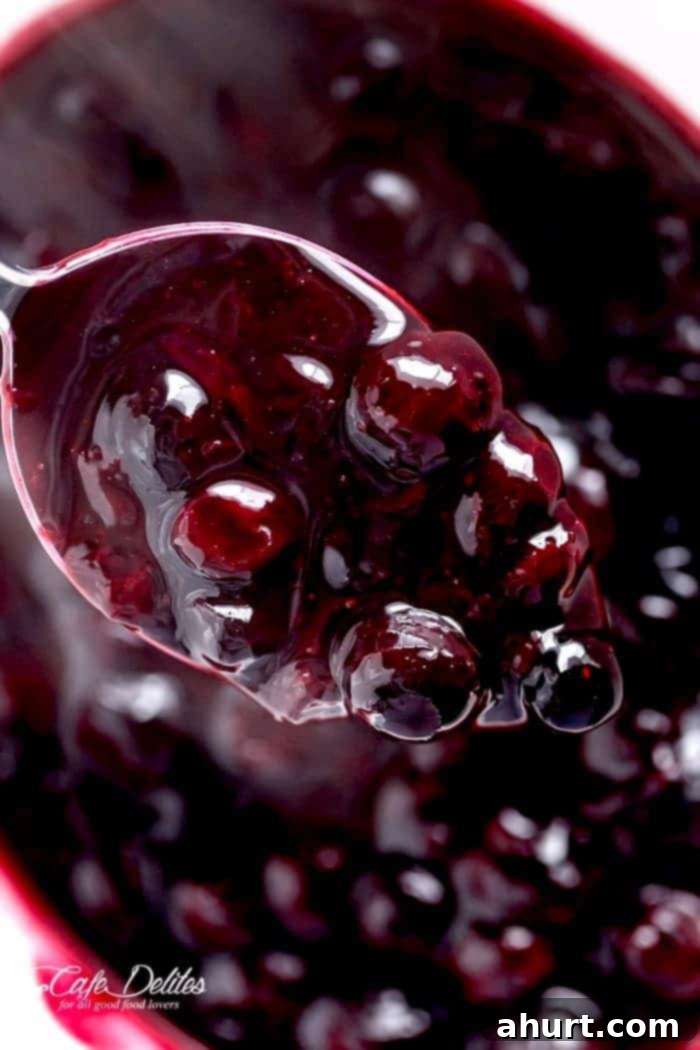 Close-up of vibrant blueberry sauce with whole and burst blueberries