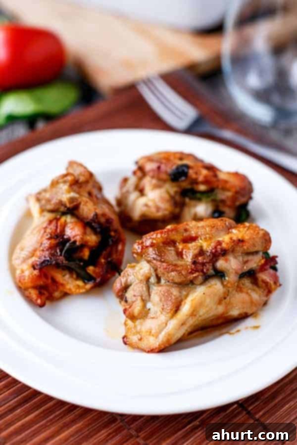 Feta Bacon Sundried Tomato Chicken Roulades 2 Fetta and Sundried Tomato Stuffed Chicken and Spinach Rolls on a plate