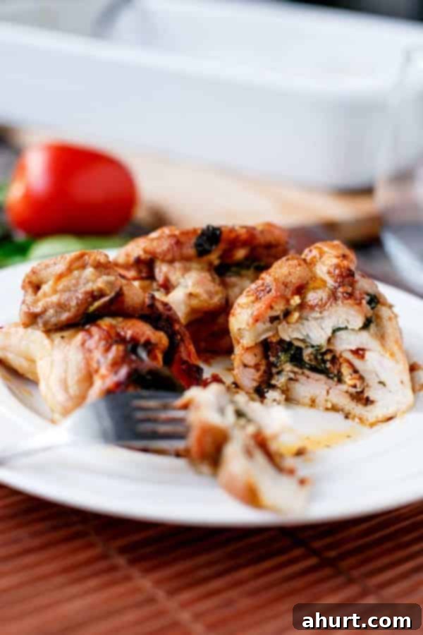 Feta Bacon Sundried Tomato Chicken Roulades 3 Fetta and Sundried Tomato Stuffed Chicken and Spinach Rolls cut into piece