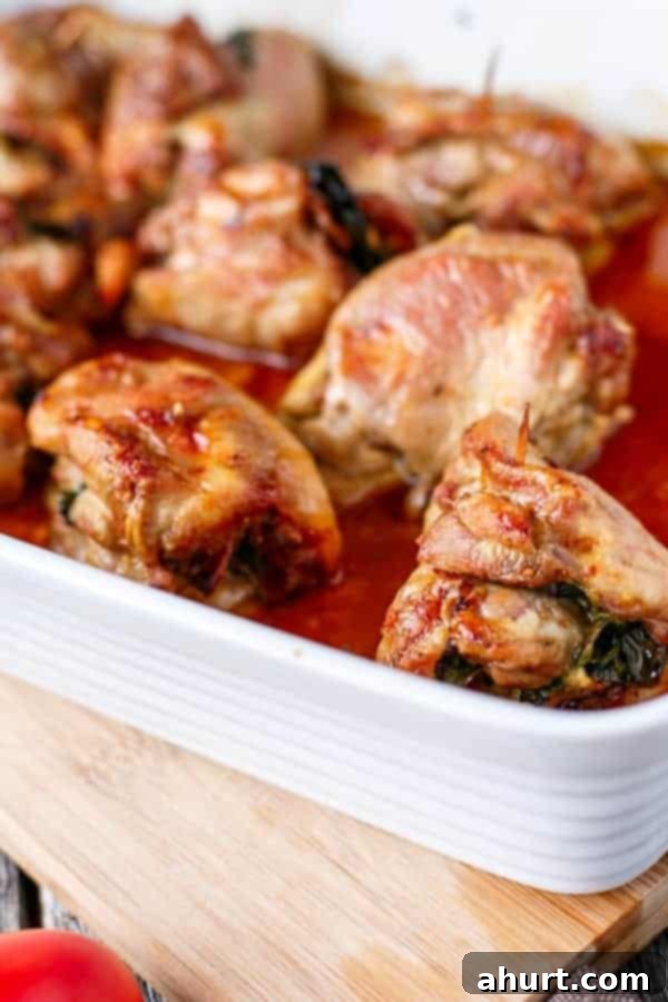 Feta Bacon Sundried Tomato Chicken Roulades 7 Fetta and Sundried Tomato Stuffed Chicken and Spinach Rolls on a tray