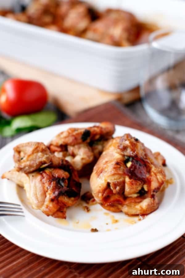 Feta Bacon Sundried Tomato Chicken Roulades 8 Fetta and Sundried Tomato Stuffed Chicken and Spinach Rolls on a plate with fork