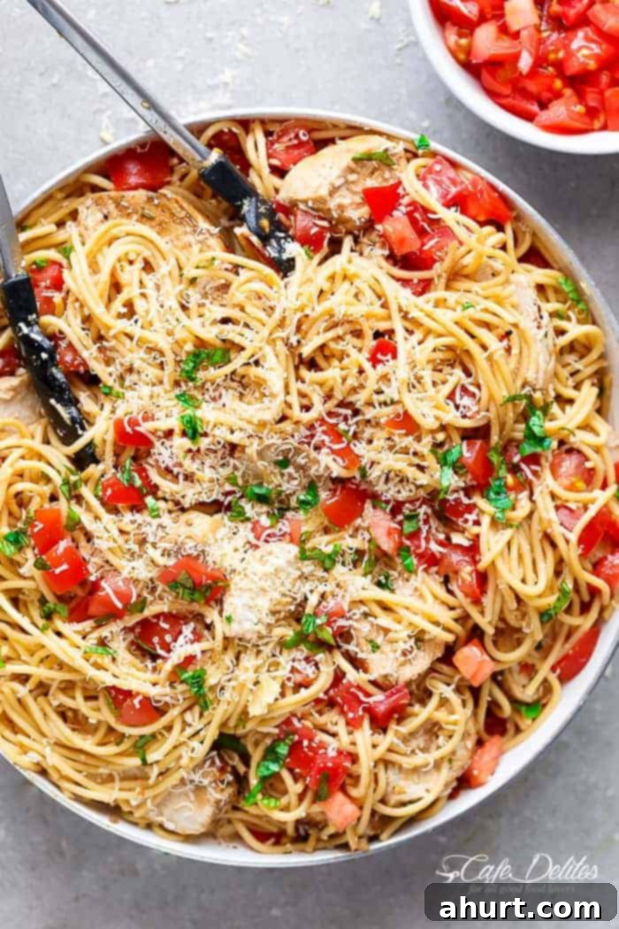 Summer Bruschetta Chicken Pasta Salad 5 Top view image of Bruschetta Chicken Pasta Salad is Filled with Italian seasoned grilled chicken, garlic and parmesan cheese in a bowl