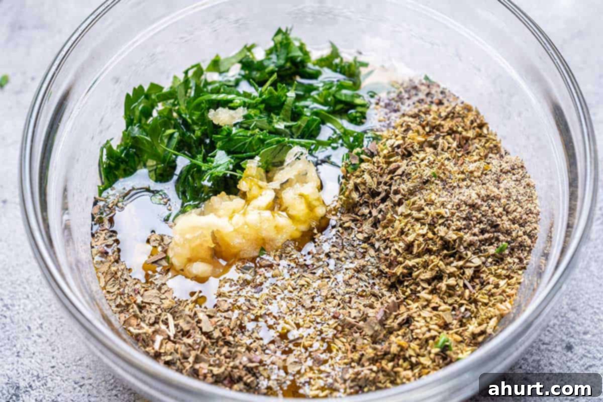 Mediterranean Grilled Lemon Herb Chicken Salad 4 Mixing bowl with minced garlic, herbs, olive oil, lemon juice, seasonings and vinegar for the Mediterranean marinade