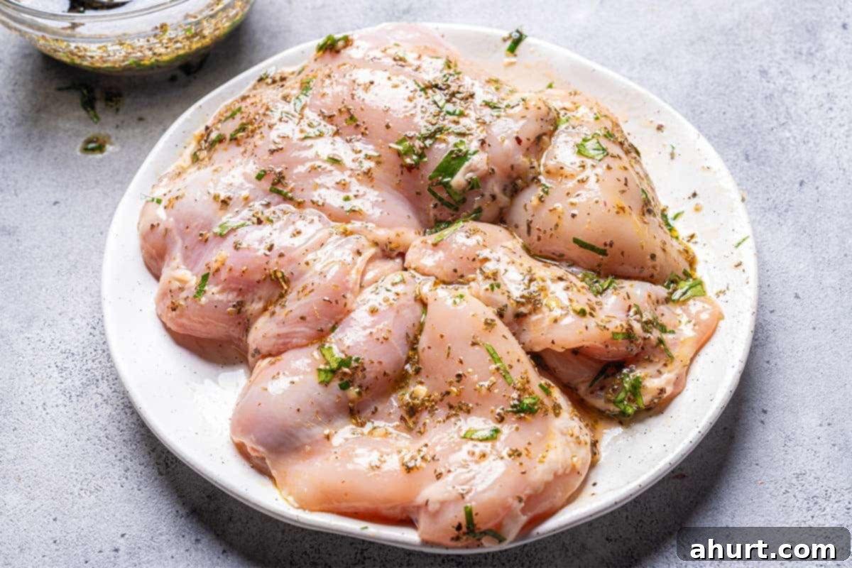 Mediterranean Grilled Lemon Herb Chicken Salad 5 Chicken breasts resting in a bowl of Mediterranean marinade