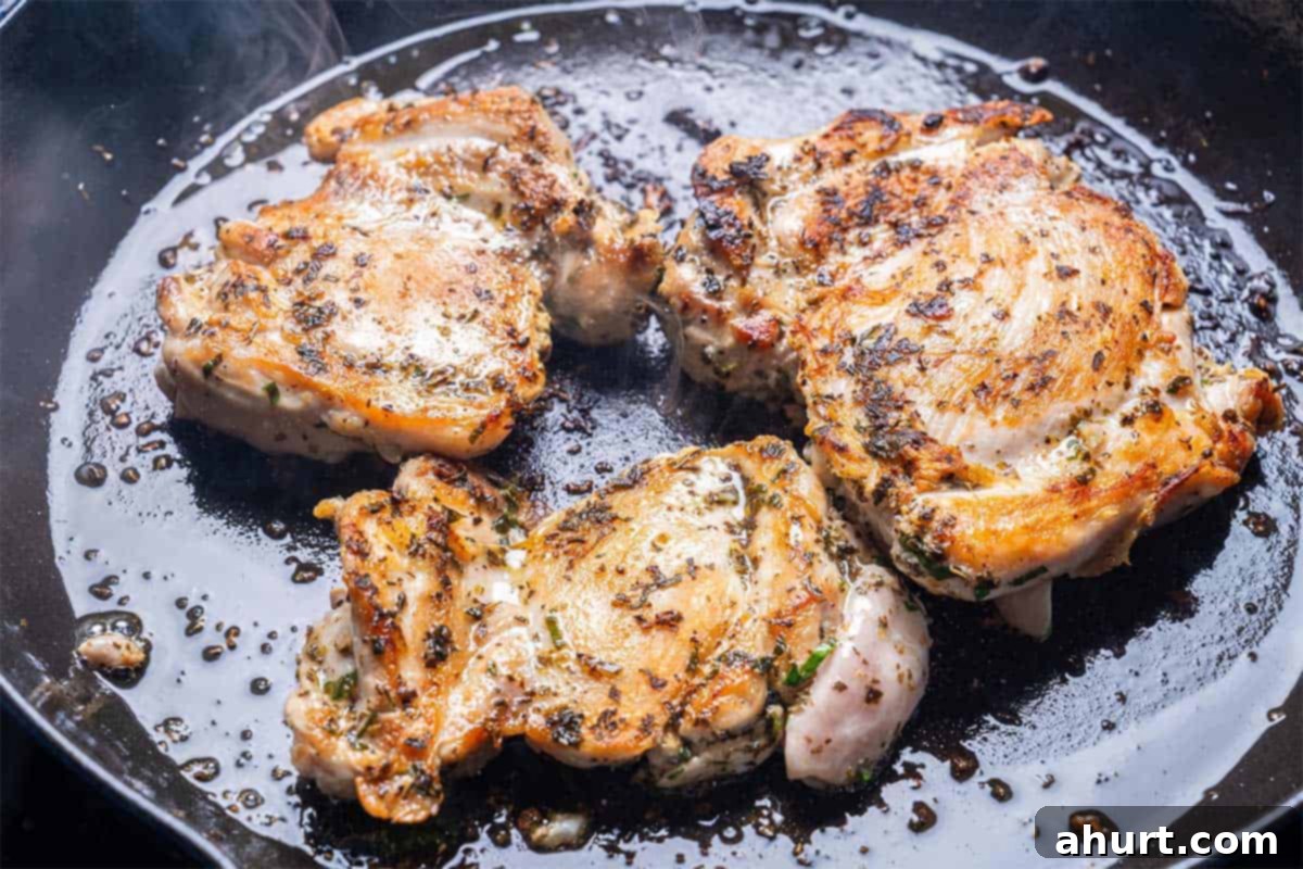 Mediterranean Grilled Lemon Herb Chicken Salad 6 Marinated chicken being grilled on a hot skillet, showing char marks
