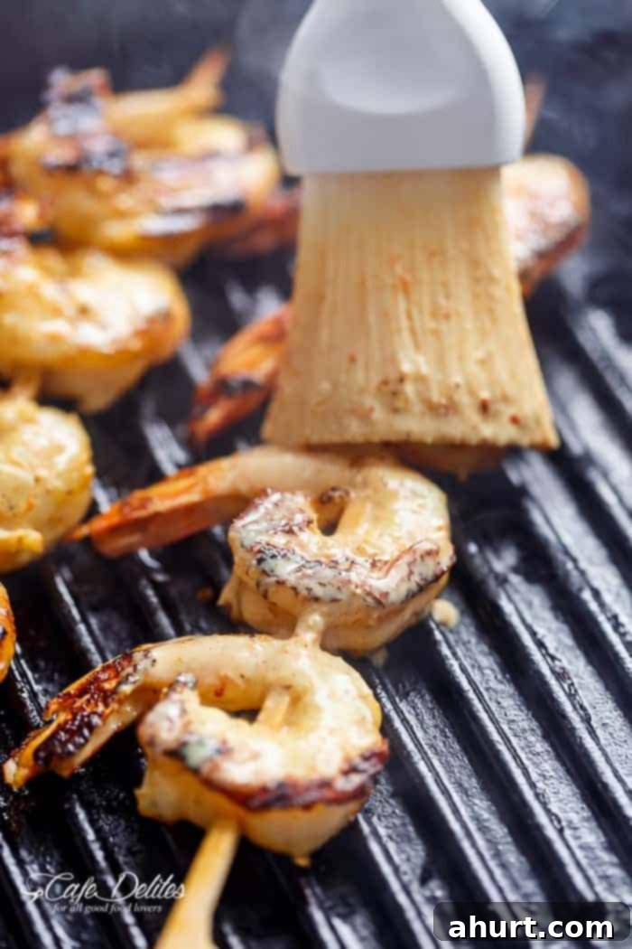 dressing coating on raw shrimp on a griller 