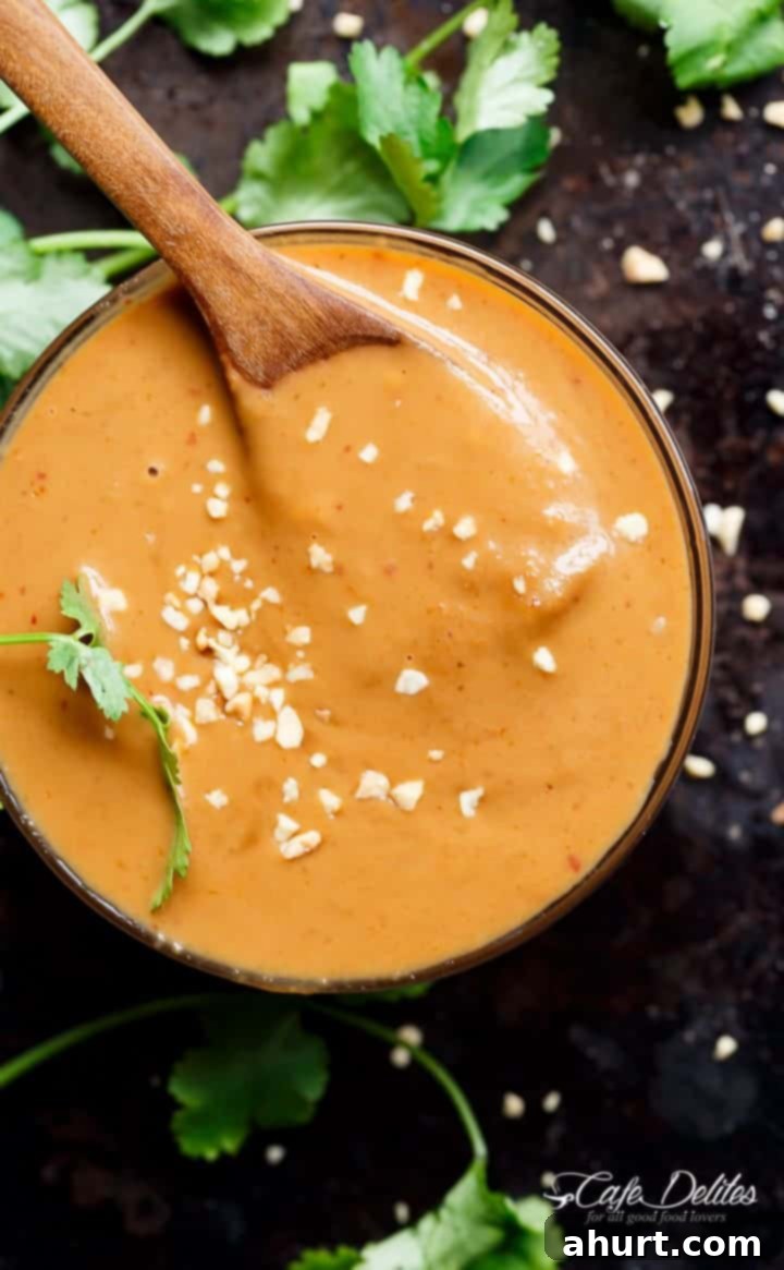 Quick and Creamy Satay Dip 2 Rich and creamy homemade Satay Dipping Sauce in a bowl with a wooden spoon, ready to serve.