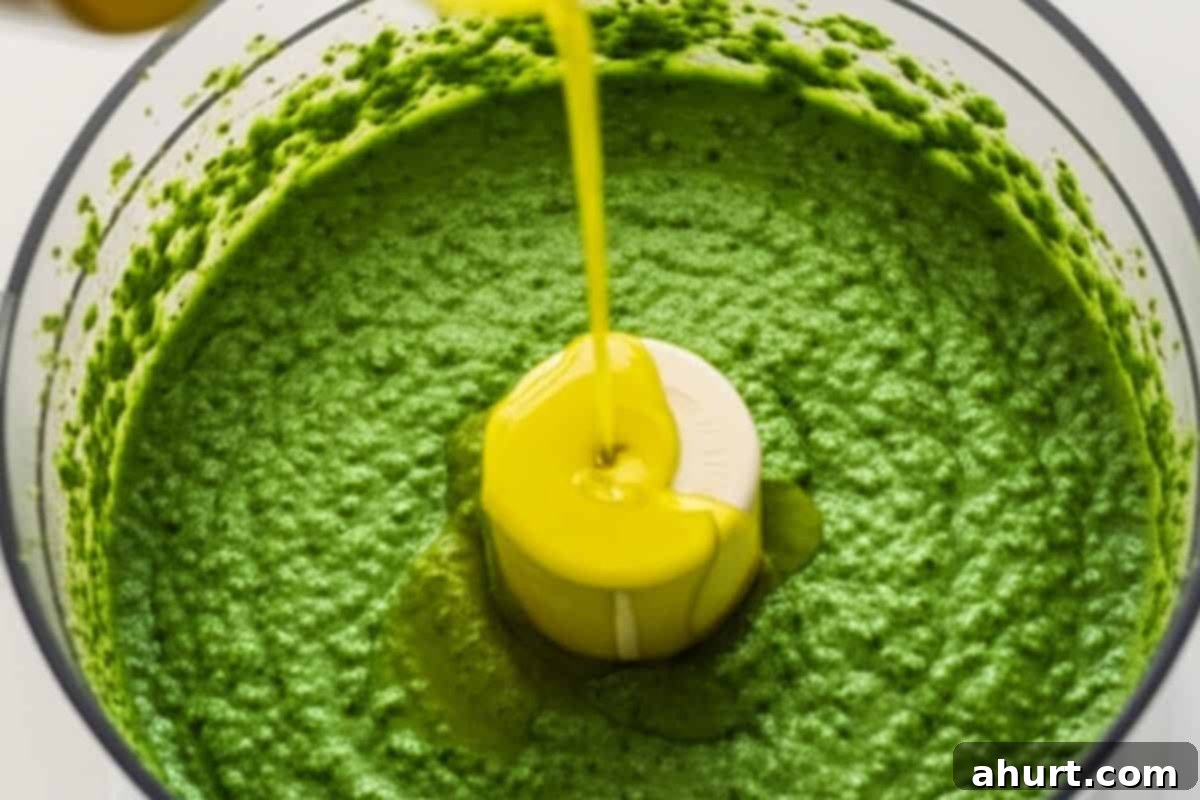 Freshly Made Basil Pesto Perfection 6 With the food processor running, slowly pour in the olive oil in a thin, steady stream to emulsify the pesto into a smooth, luscious sauce.