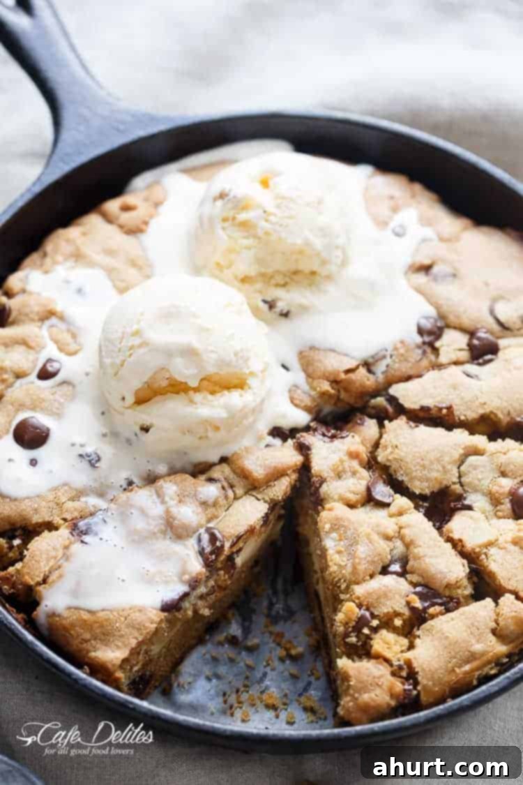 Cheesecake Stuffed Pizookie 2 Top view image of Cheesecake Stuffed Skillet Cookie with ice cream scoop on top