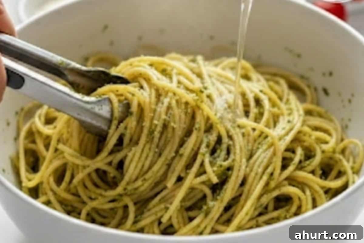 Vibrant Pesto Chicken Spaghetti 8 Add the remaining basil pesto to the cooked spaghetti with the 1/2 cup reserved pasta water. Toss until fully combined and glossy.