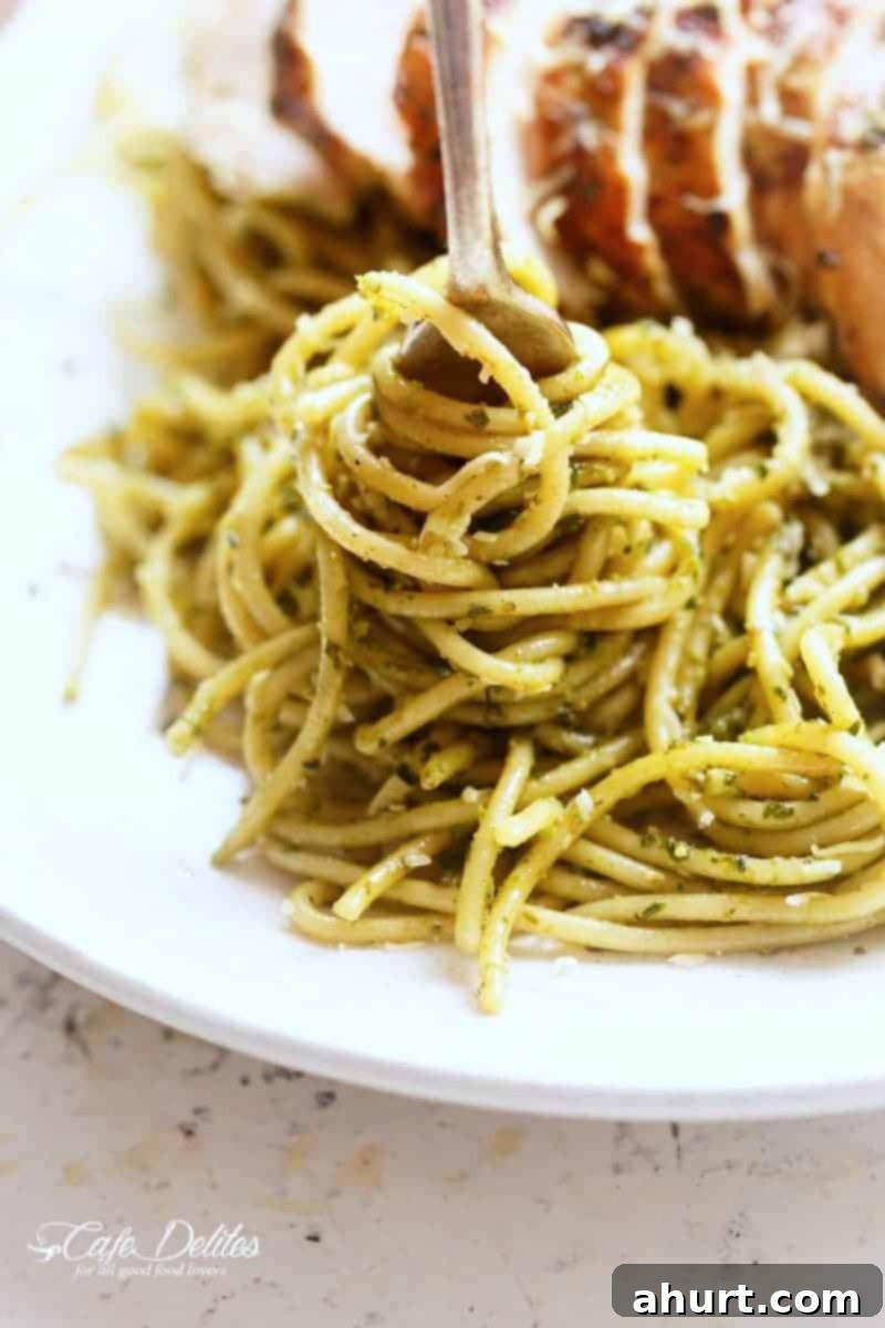Vibrant Pesto Chicken Spaghetti 10 Spaghetti rolled over the fork from Basil Pesto Chicken Spaghetti, showing the rich pesto coating and tender chicken pieces