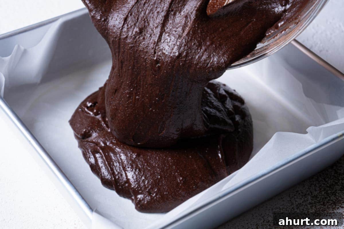 Decadent Cocoa Fudge Brownies 8 Image of the batter being poured into a prepared pan.