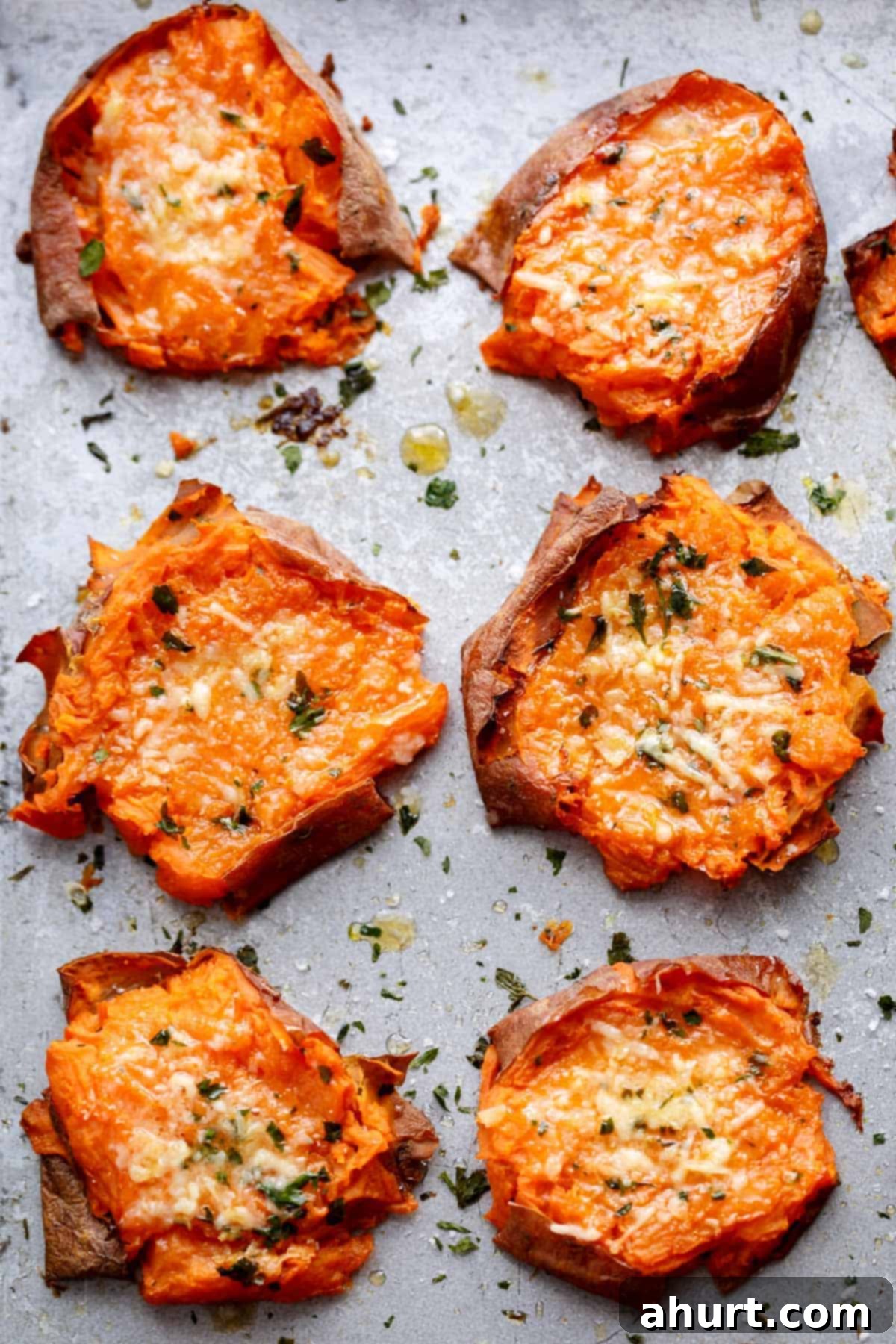 Golden Garlic Parmesan Smashed Sweet Potatoes 2 Pieces of Garlic Butter Smashed Sweet Potatoes With Parmesan kept on baking paper