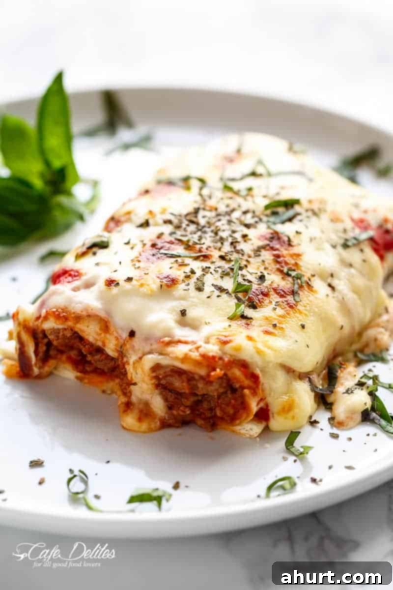 A piece of Easy Lasagna Stuffed Burritos on a plate 