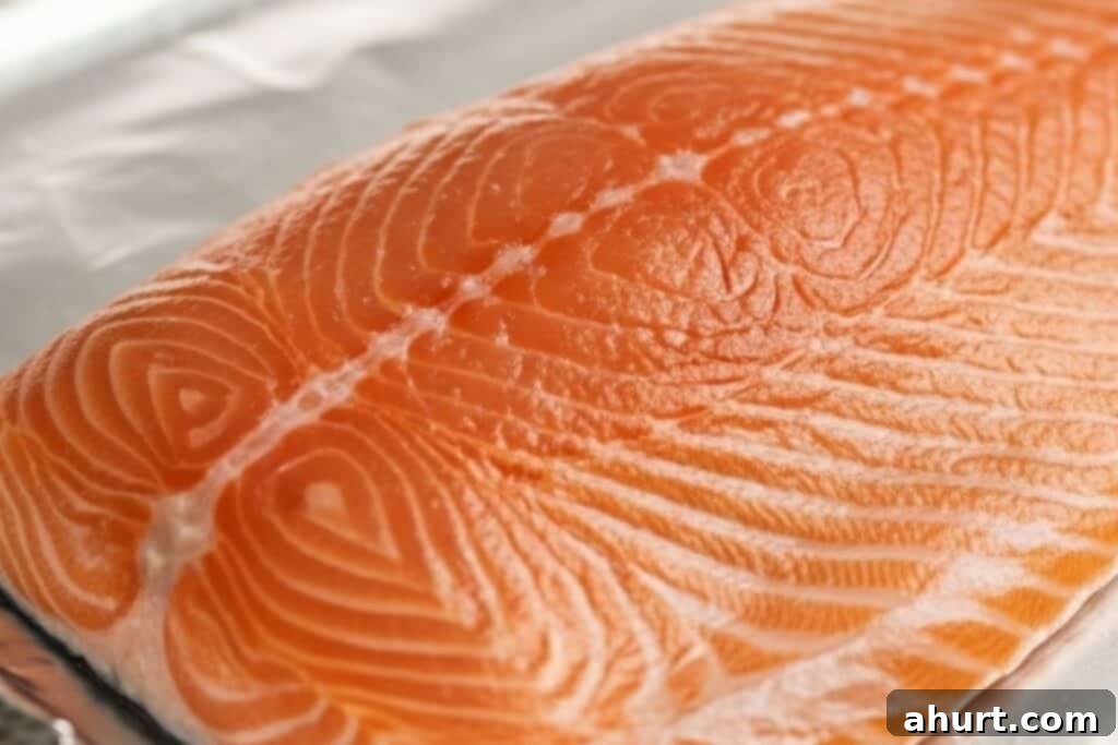 Crispy Parmesan Salmon 4 Salmon fillet placed on a foil-lined baking sheet.