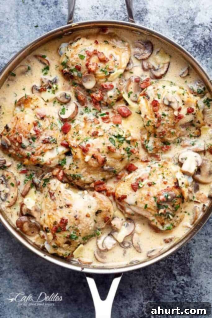 Luscious Creamy Garlic Parmesan Chicken 2 A top-down view of Creamy Garlic Parmesan Chicken served in a skillet, garnished with fresh parsley.