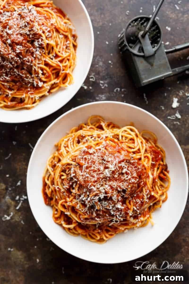 Fall-Apart Tender Slow Cooker Beef Ragu 12 Two generously filled bowls of Slow Cooker Beef Ragu, garnished with fresh herbs, ready for a comforting meal.