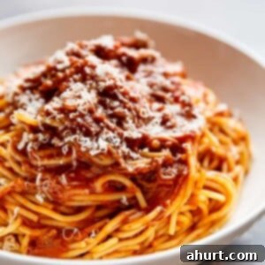 Fall-Apart Tender Slow Cooker Beef Ragu 13 A vibrant bowl of Slow Cooker Beef Ragu, showcasing the rich tomato sauce and tender shredded beef, ready to be served.