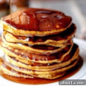 Autumn Caramel Chip Pumpkin Pancakes 8 A perfectly stacked plate of Caramel Chip Pumpkin Pancakes, ready to be served