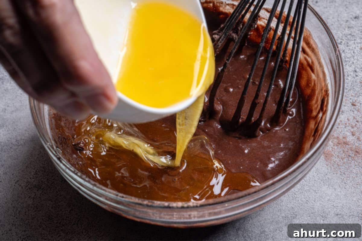 Molten Chocolate Fudge Pudding Cake 4 brown chocolate mix with a wisked egg being poured in close up