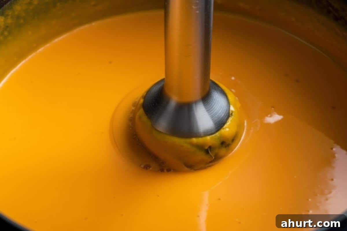Velvety Golden Pumpkin Soup 6 Pureeing the soup directly in the pot.