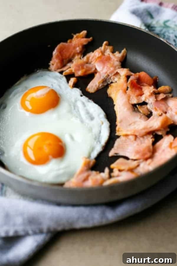 Crispy Smoked Salmon, Golden Egg Stack 3 Egg fry with Smoked Salmon pieces in a pan