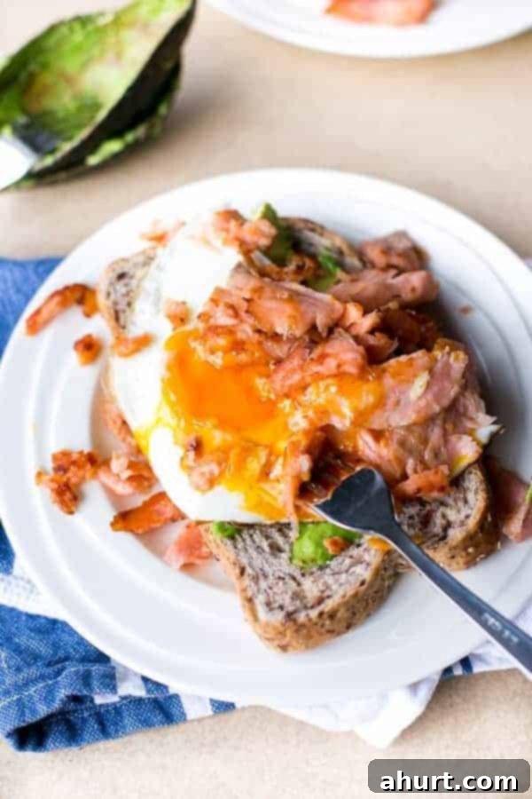 Crispy Smoked Salmon, Golden Egg Stack 5 Crispy Smoked Salmon and Fried Egg Stack on a plate with fork