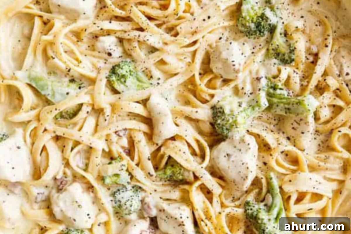 Easy One Pot Chicken Bacon Fettuccine Alfredo 11 Close-up shot of creamy Chicken Bacon Fettuccine Alfredo, garnished with fresh herbs and ready to serve.