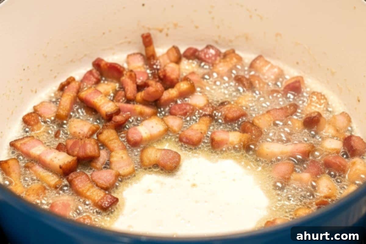 Easy One Pot Chicken Bacon Fettuccine Alfredo 4 Frying the chopped bacon in a large pot until golden and crispy, releasing delicious aromas.