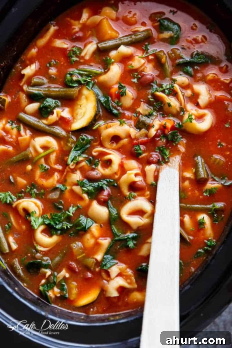 Comforting Crockpot Tortellini Minestrone 2 Zoom in image of Slow Cooker Tortellini Minestrone Soup in a bowl