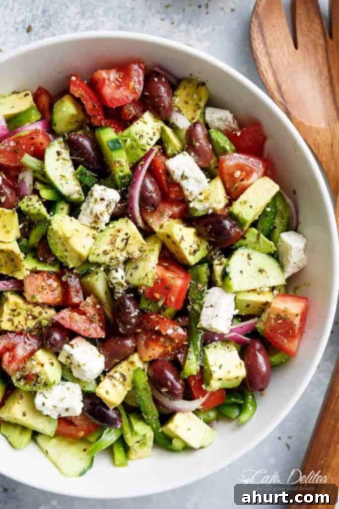 Perfect Greek Salad 2 Avocado Greek Salad with a homemade Greek Salad Dressing in a bowl, showcasing its vibrant colors and fresh ingredients.