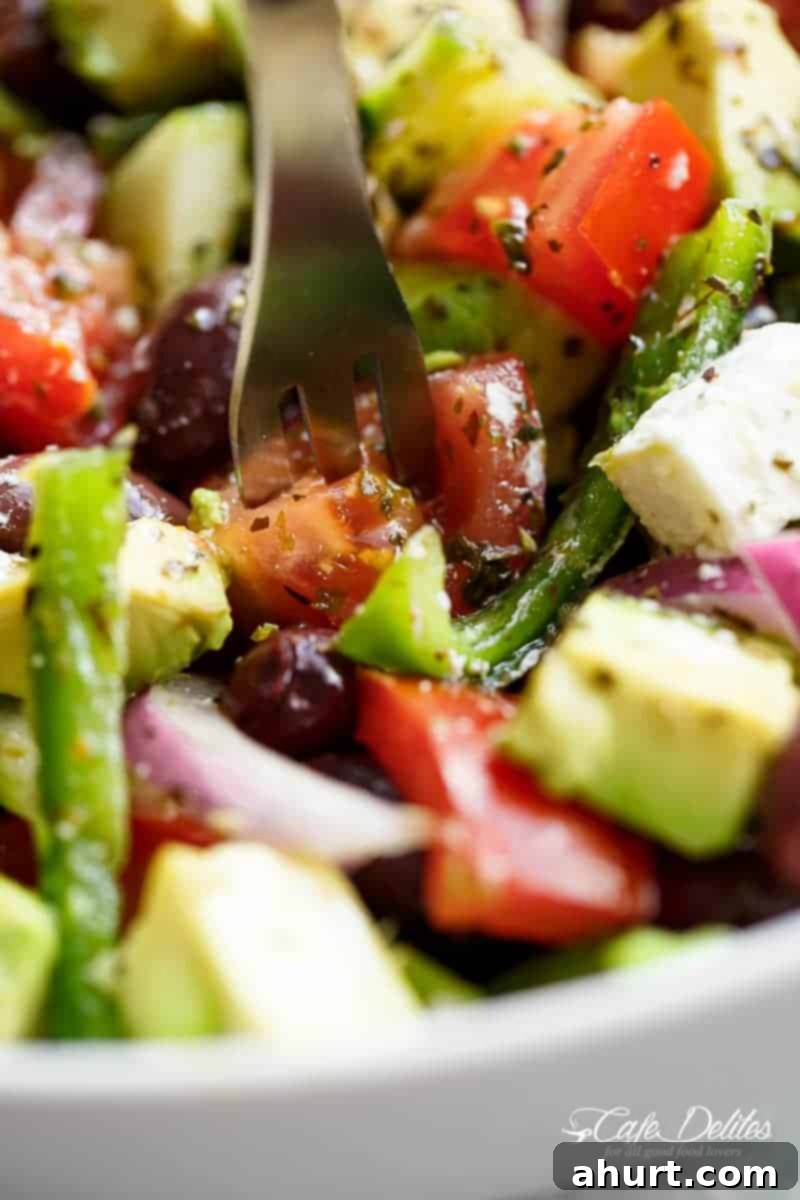 Perfect Greek Salad 8 Avocado Greek Salad & Greek Salad Dressing, beautifully arranged in a bowl.