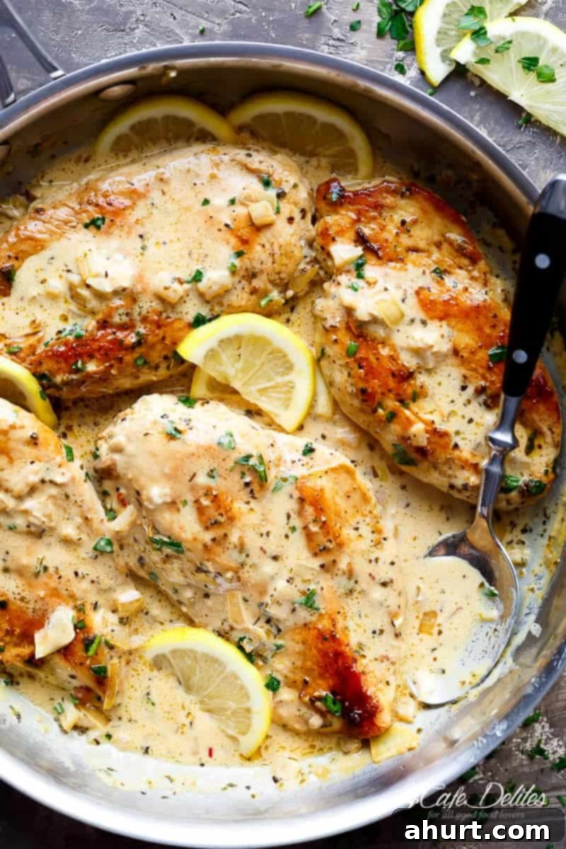 Lemon Chicken Scallopini with Lemon Garlic Cream Sauce in a skillet, showcasing golden chicken cutlets submerged in the rich, creamy sauce.
