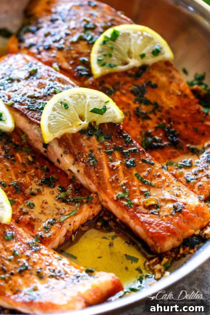 Pan Seared Salmon with Lemon Garlic Butter Sauce with lemon wedges